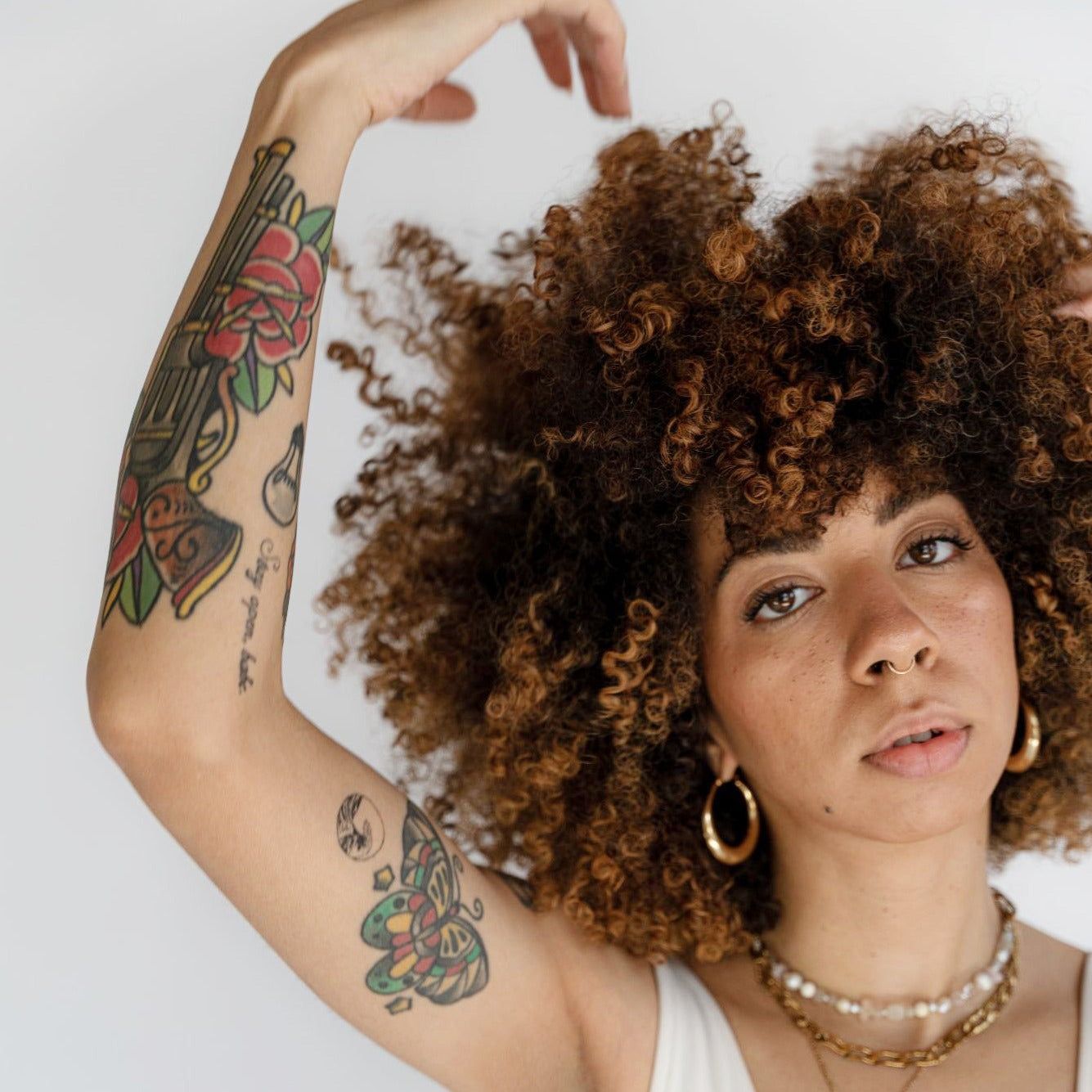 Close up of a woman with healthy, defined, shiny curly hair.